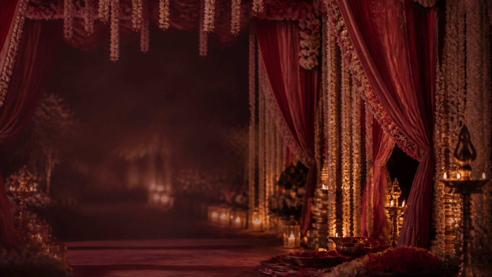 A candlelit floral mandap prepared for the wedding