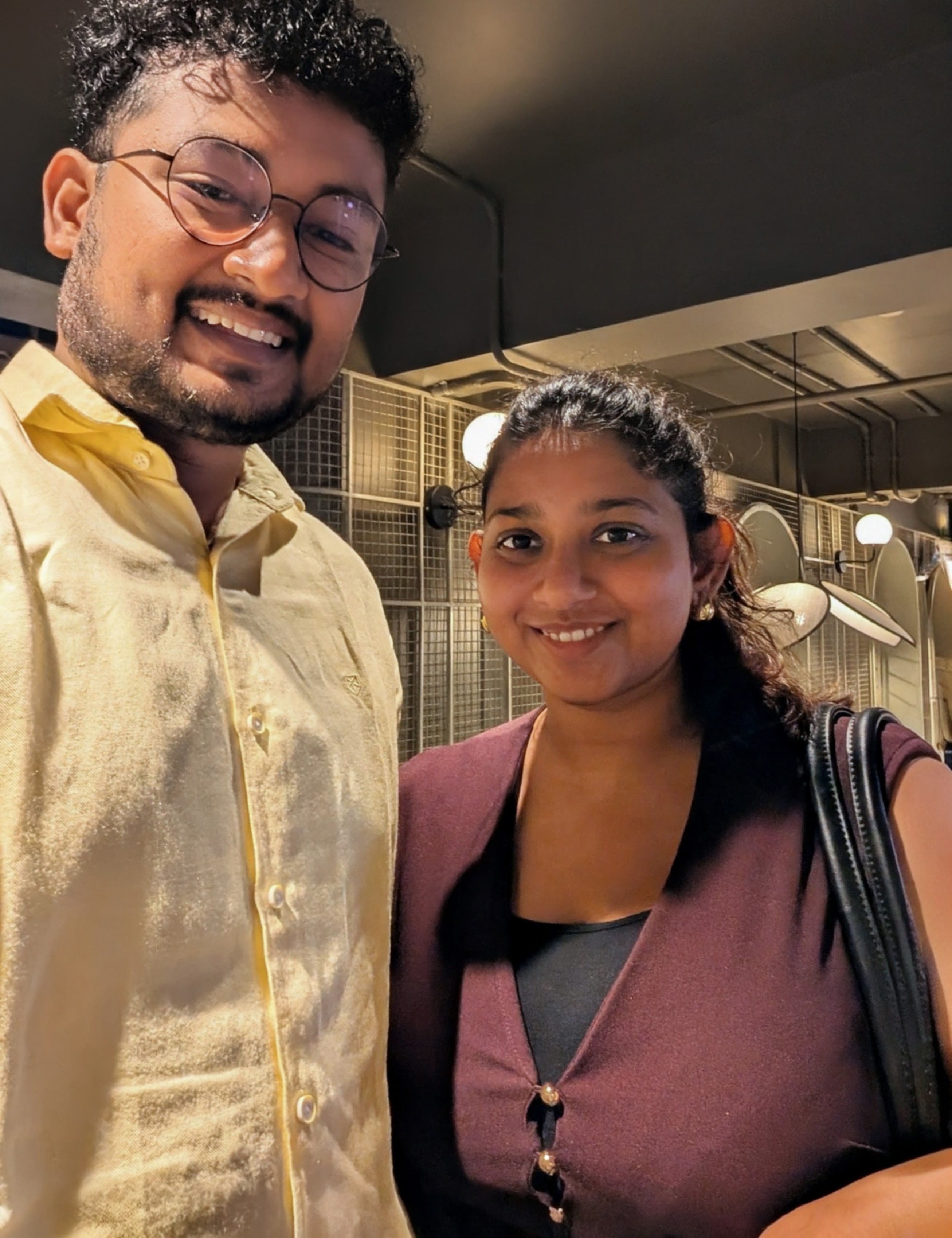 Rajshree and Deepesh smiling together indoors
