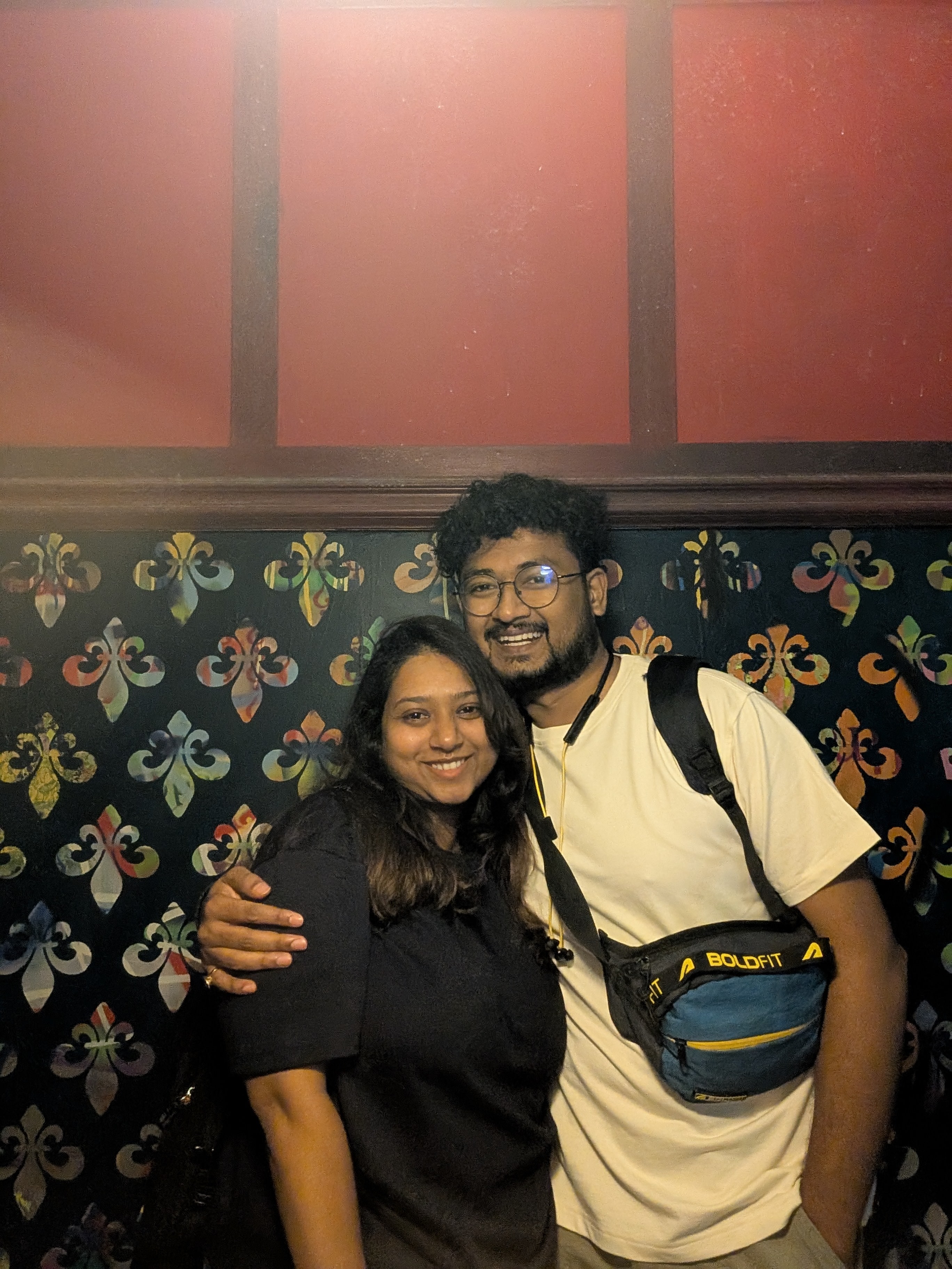 Rajshree and Deepesh in front of a patterned wall