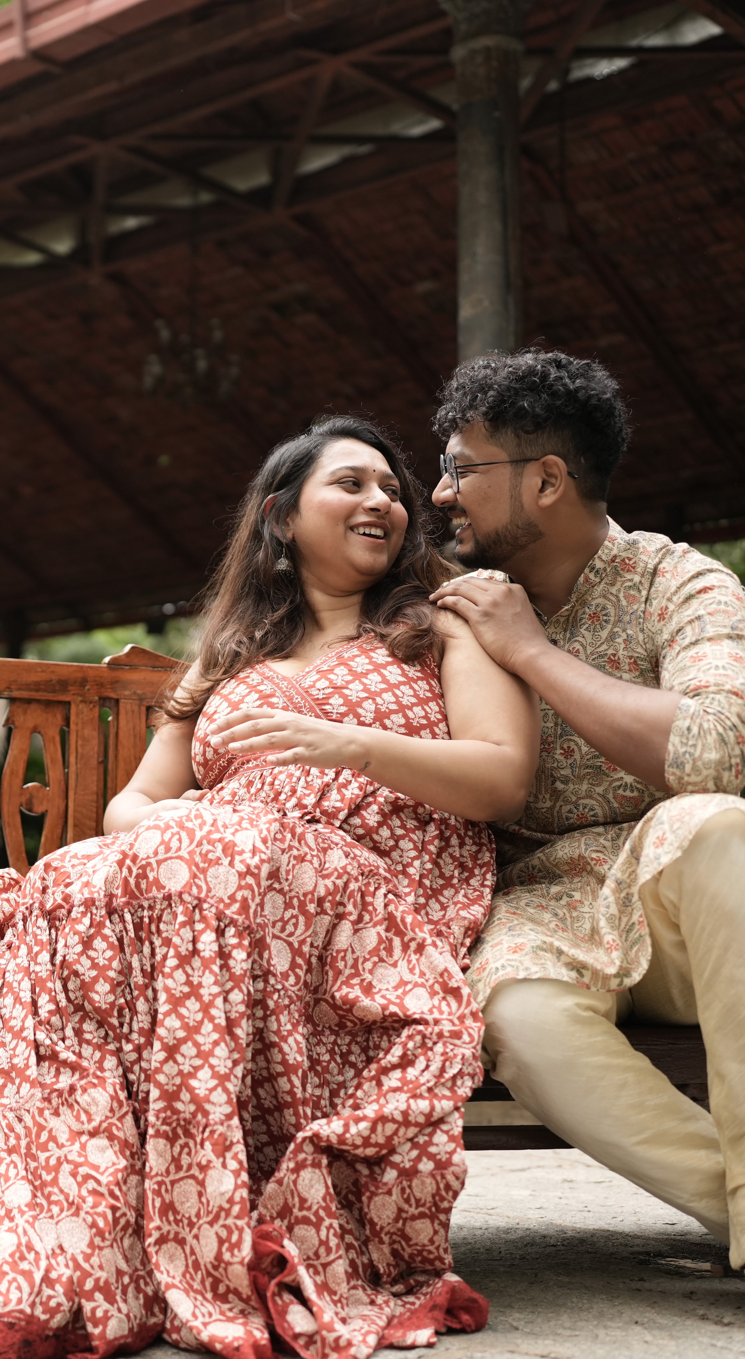 Rajshree and Deepesh smiling together on a bench